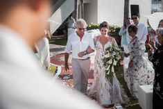 the bride and groom are walking down the aisle