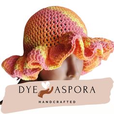 a crocheted hat with ruffles on top and the words dye aspora handcrafted above it