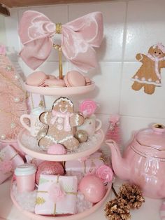 a pink tea set with teddy bears, cookies and other items on it's stand