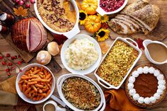 an assortment of thanksgiving foods laid out on a table