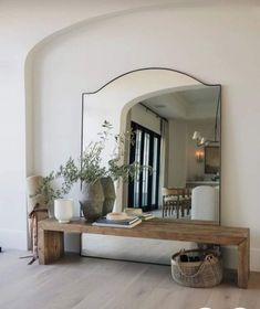 a mirror sitting on top of a wooden table