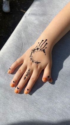 a woman's hand with tattoos on it and the word love written in black ink