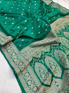 This is a very beautiful high quality mashru silk saree . All over zari motifs design with border . Saree length - 5.5 mtr. Blouse - 1 mtr. Dry clean only . Please note - color may be vary a little due to sunlight and photography . Please message us after purchasing in case you want fall and Pico done it not . No extra charges for fall and Pico but inform us . Blouse stitching is also available . Designer Green Saree With Motifs, Green Dola Silk Saree With Motifs, Elegant Green Dola Silk Saree, Elegant Green Saree For Puja, Designer Banarasi Silk Saree For Eid, Elegant Green Katan Silk Saree, Green Katan Silk Saree With Motifs, Designer Saree With Traditional Patterns, Elegant Green Paithani Silk Dupatta