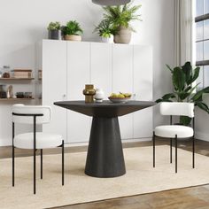 a dining room with white chairs and a black table in the middle, surrounded by potted plants