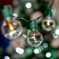 some lights are hanging from a string on a christmas tree