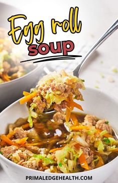 two bowls filled with egg roll soup on top of a white table next to a spoon