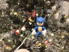 two sonic and tails figurines sitting on top of a christmas tree