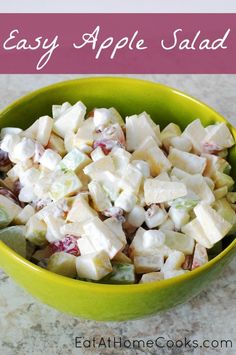 a green bowl filled with apple salad on top of a counter next to a pink and white sign that says easy apple salad