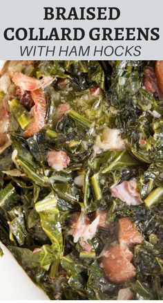 a white bowl filled with cooked collard greens and ham hocks on top of a wooden table