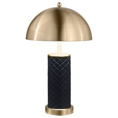 a black and gold table lamp on a white background