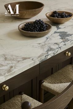 marble counter top with two bowls on it and one bowl full of black beans in the middle