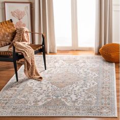 a living room area with a chair, rug and large window in front of it