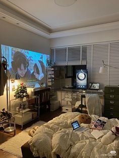 a bed room with a large screen tv on the wall