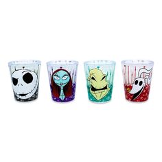 three different colored glasses with cartoon characters painted on the glass and one has an evil face