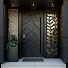 a black door with gold leaves on it and a potted plant in the middle