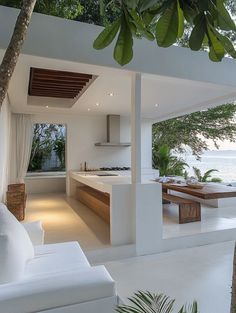 an outdoor kitchen and living room area overlooking the ocean