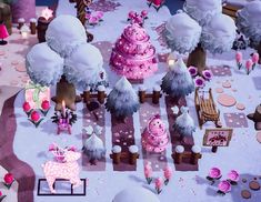 a pink and white christmas scene with trees, snow covered ground, candles and decorations