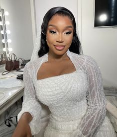 a woman in a wedding dress posing for the camera