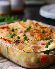 a casserole dish with peas and ham