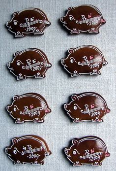 six chocolate pig shaped magnets sitting on top of a table