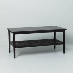 a black coffee table sitting on top of a white floor