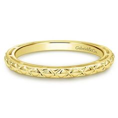 a yellow gold wedding band with an intricate design