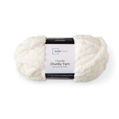 chunk yarn in white, on a white background with black and white tagline for the label