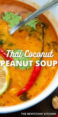 thai coconut peanut soup in a bowl with garnishes and lime on the side