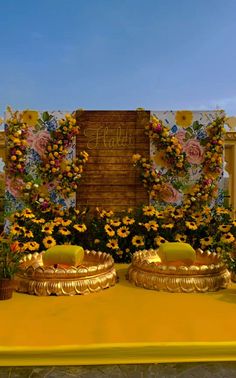 a yellow table topped with lots of flowers