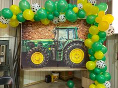 a tractor balloon arch with green and yellow balloons