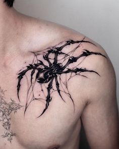 a man with a spider tattoo on his chest