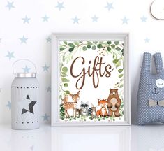 a white shelf topped with stuffed animals next to a wall mounted art print that says gifts