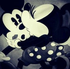 two mickey mouses hugging each other in black and white