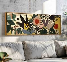 a painting hanging on the wall above a couch