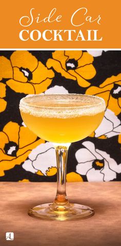 the side car cocktail in a coupe glass with an orange and white flowered background