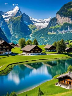 the mountains are covered in snow and green grass, with small houses on each side