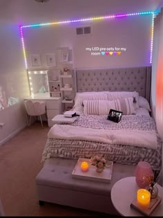 a bed room with a neatly made bed and lights