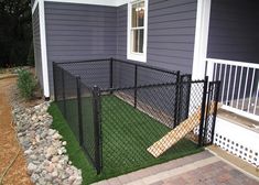 a black chain link fence in front of a house