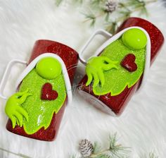 two red and green cup holders sitting on top of a white furnishing covered floor