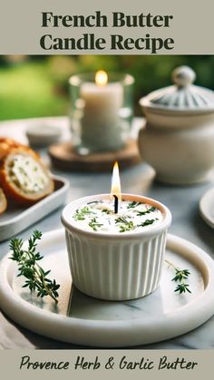 a candle that is sitting in a bowl on a plate with bread and other food