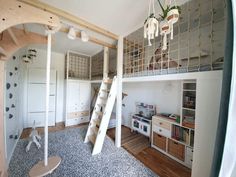 a room with bunk beds, shelves and ladders on the wall next to it