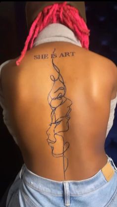 the back of a woman's body with a tattoo on it