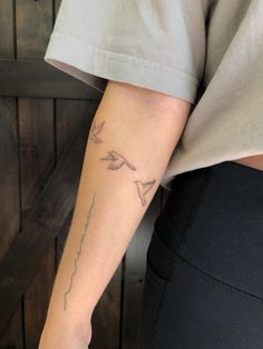 a person with a bird tattoo on their arm and the word love written in cursive writing