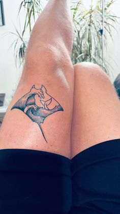 a woman's legs with a tattoo on them