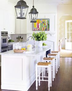 the kitchen is clean and ready to be used for cooking or eating, with stools in front of the island