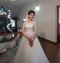 a woman in a white wedding dress posing for the camera