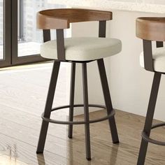 two wooden stools with white upholstered seats in front of an open window