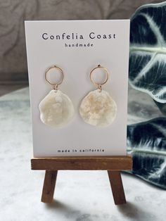 100% Handmade white jingle shells are arranged as beautiful drop earrings. They are very lightweight , great for all day wear. These nickel-free earrings feature gold-plated circle stud findings for comfort and simple aesthetic .  The shells for each pair are hand picked, and are meticulously assembled. These earrings have an organic and minimal look while still being very versatile. Would even make a beautiful addition to a beach bridal look. Please note,  each shell and by extension each pair have its own characteristics making them beautifully one of a kind . Adjustable White Mother Of Pearl Earrings, Bohemian White Mother Of Pearl Earrings, White Teardrop Earrings For Beach, White Earrings With Ear Wire For Vacation, White Ear Wire Earrings For Vacation, White Shell-shaped Earrings For Vacation, White Shell Dangle Jewelry, White Shell Earrings With Pearl Drop, White Shell-shaped Pearl Drop Earrings