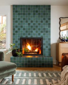 a living room with a fire place in the center and a chair next to it