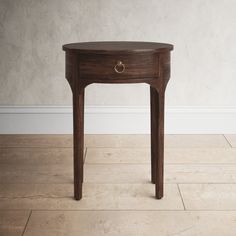 a small wooden table sitting on top of a hard wood floor next to a wall